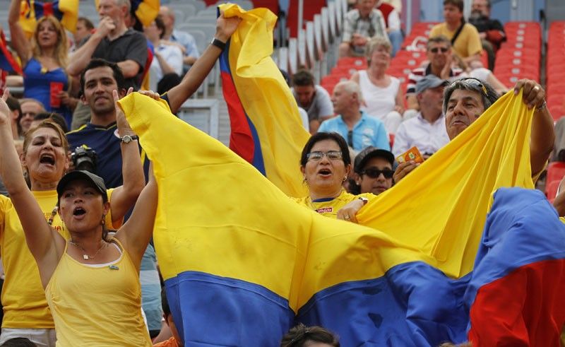 Colombian soccer fans cheer for their team