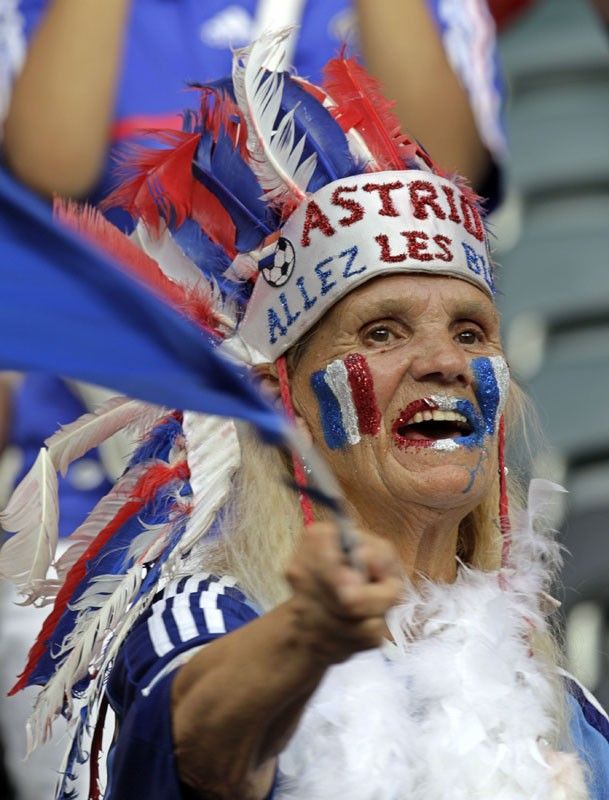 A supporter of France cheers the team