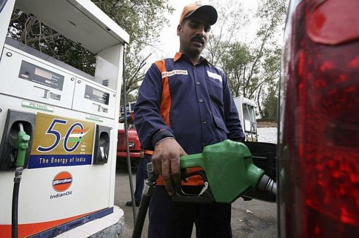 An employee fills a car with petrol at a gas station in Jammu February 26, 2010. India will raise petrol and diesel prices from Friday midnight, Oil Secretary S. Sundareshan told reporters.