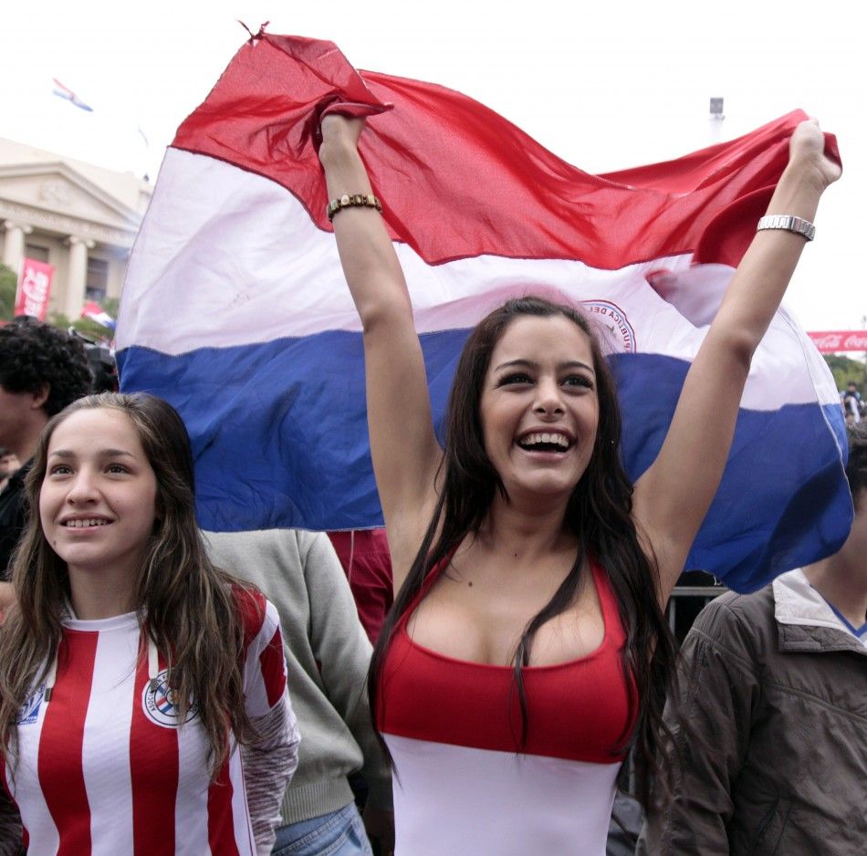 Paraguayan model Larissa Riquelme waves her national flag during a public screening of the World Cup soccer match between Paraguay and Japan in Asuncion