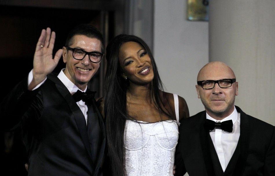 British model Naomi Campbell C smiles next to Italian designers Domenico Dolce R and Stefano Gabbana during a party marking the 25th anniversary of her career in downtown Shanghai October 28, 2010. 