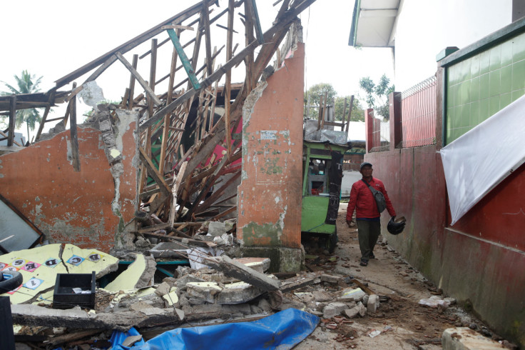 A man walks near a destroyed kindergarten affected by the earthquake in Cugenang