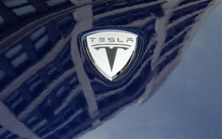 A logo of Tesla Motors on an electric car model is seen outside a showroom in New York