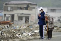 Yae Kubota and her grandson pray for the victims of the earthquake and tsunami in Miyako, Iwate prefecture