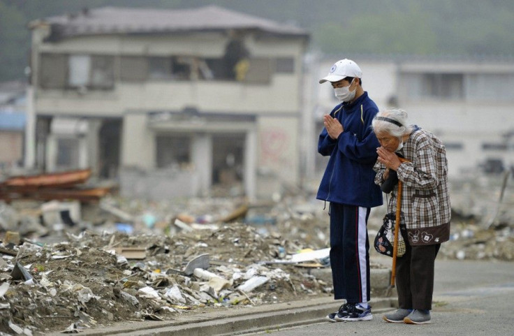 Yae Kubota and her grandson pray for the victims of the earthquake and tsunami in Miyako, Iwate prefecture