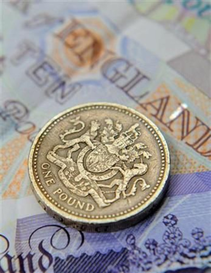 A one pound coin and sterling notes are seen in central London