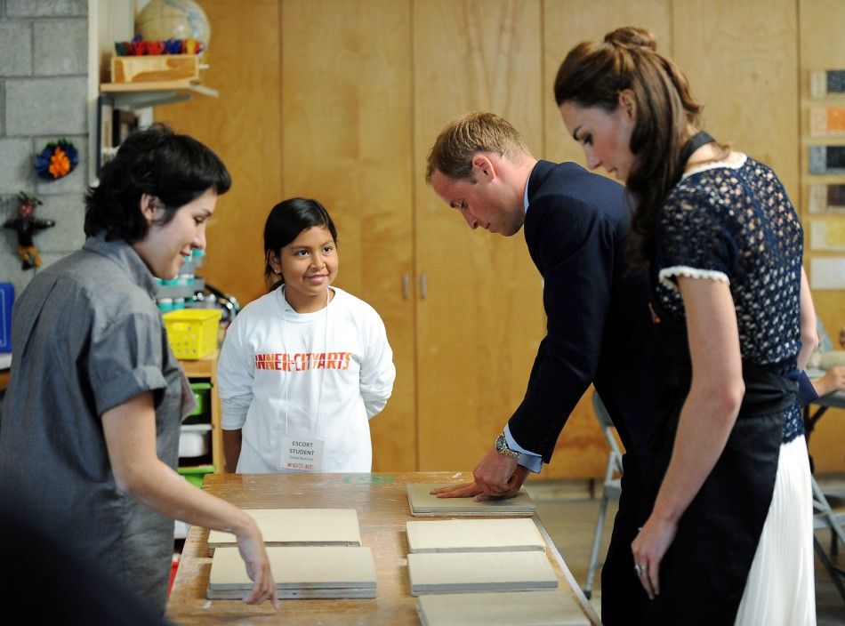 Britains Prince William and his wife Catherine, Duchess of Cambridge, make handprints in pieces of clay as a student and teacher Carmen Argote L looks on during their visit to the Inner-City Arts campus in Los Angeles, California