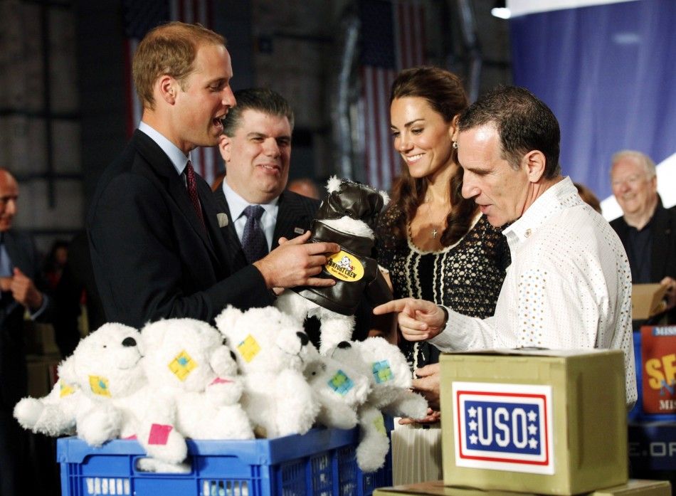 Britains Prince William L and his wife Catherine, Duchess of Cambridge 2nd R, box care packages for the United Services Organizations USO with box content designer Trevor Romain at the Mission Serve Hiring Our Heroes event in Culver City, Californ