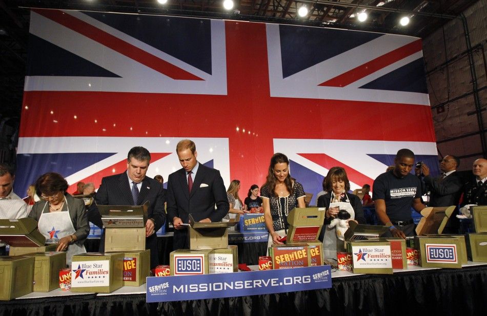 Britains Prince William 3rd L and his wife Catherine, Duchess of Cambridge C , help prepare care packages for military children as they attend the Mission Serve Hiring Our Heroes event in Culver City, California
