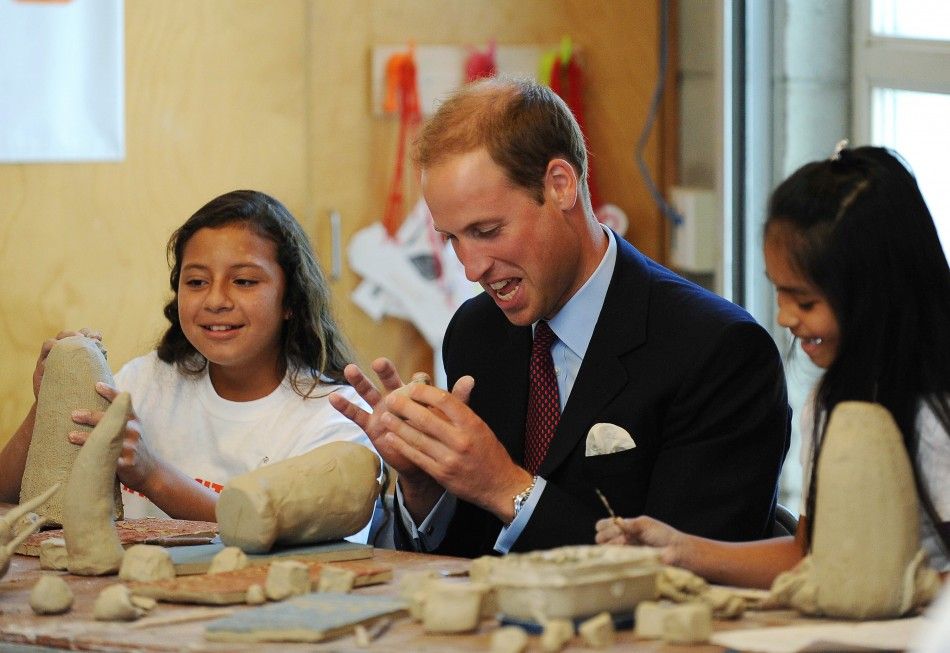 Britains Prince William works with clay with students during a ceramics class at he Inner-City Arts campus in Los Angeles