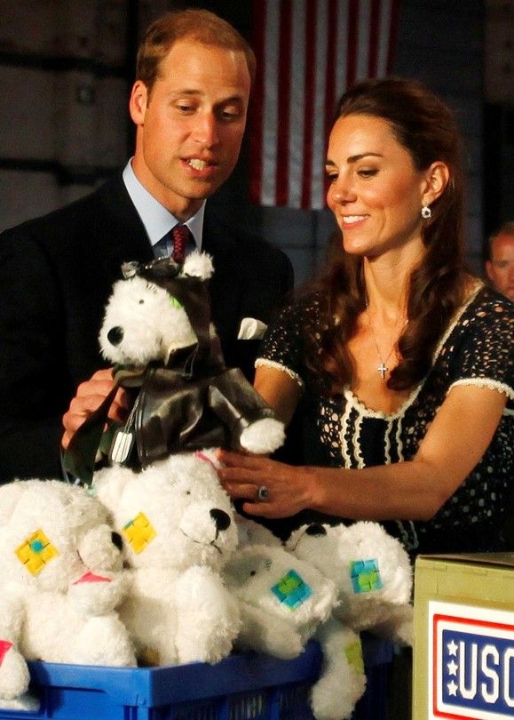 Britains Prince William and his wife Catherine, Duchess of Cambridge, hold a teddy bear which will go into care packages for militar children as they attend the Mission Serve Hiring Our Heroes event in Culver City 