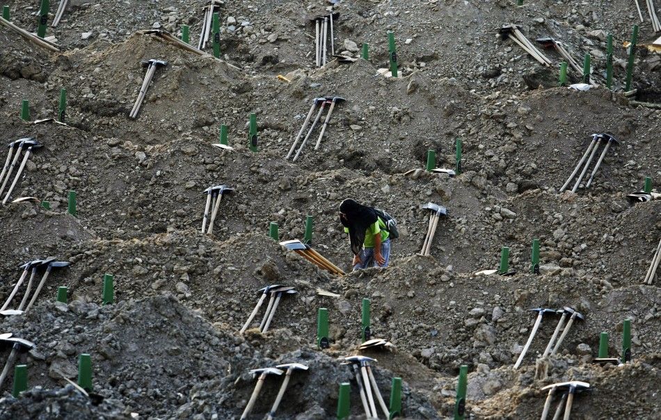 A man looks at the graves prepared for a mass burial at the Memorial Center in Potocari, near Srebenica