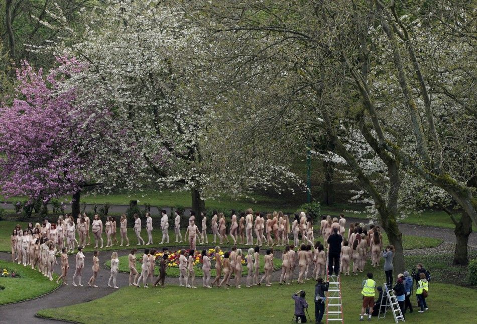 Nude models prepare to pose for a photograph by U.S. artist Tunick in Peel Park, Salford