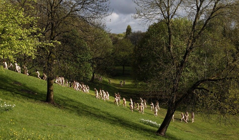 Nude models prepare to pose for a photograph by U.S. artist Tunick in Peel Park, Salford