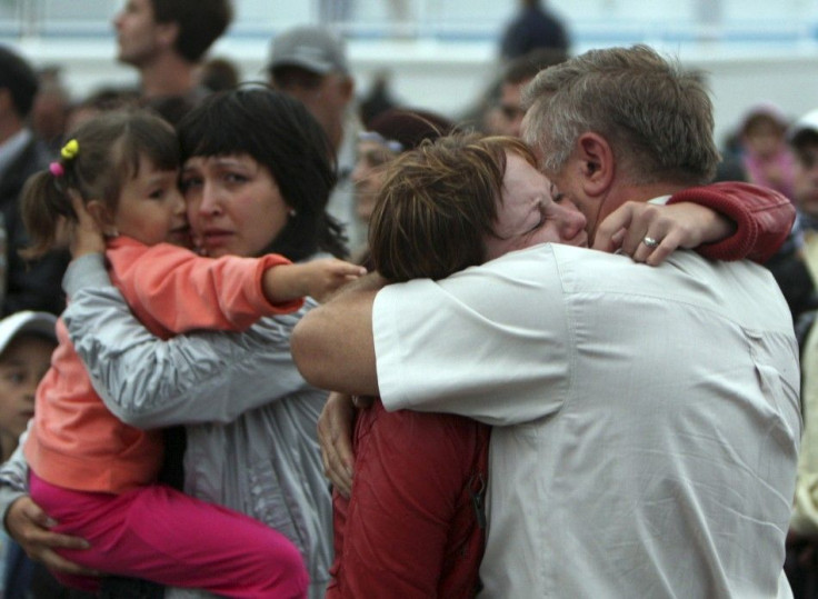 People react as they meet the survivors from the Bulgaria tourist boat, which sank on the Volga river, at the port of Kazan