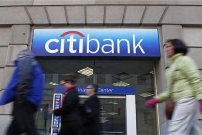 Pedestrians walk past a Citibank branch in Washington