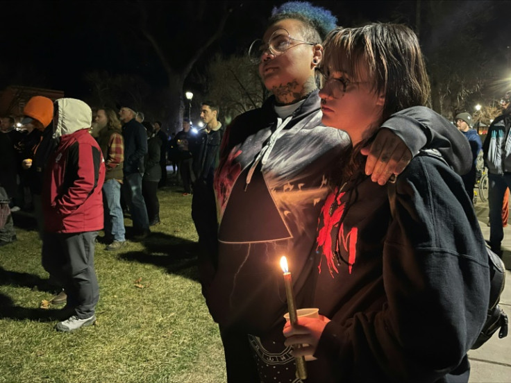 People hold candles during a vigil at Acacia Park for the victims of a mass shooting at Club Q, an LGBTQ venue in Colorado Springs in the US state of Colorado