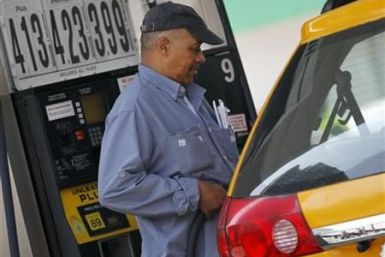 A taxicab driver fills his tank at a gas station in Midtown Manhattan