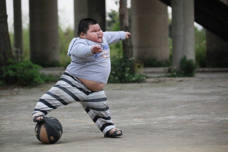 Lu Zhihao kicks a ball at a basketball court in Foshan