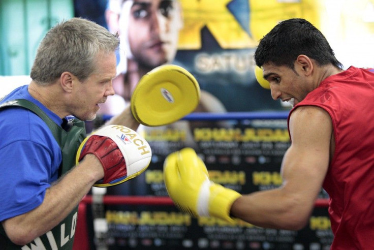 British boxer Amir &quot;King&quot; Khan spars with trainer Freddie Roach at Wildcard Boxing Club in Los Angeles