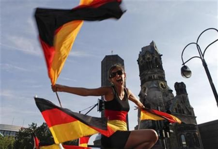 Woman waves the German flag near Gedaechtniskirche (Memorial Church) in Berlin 