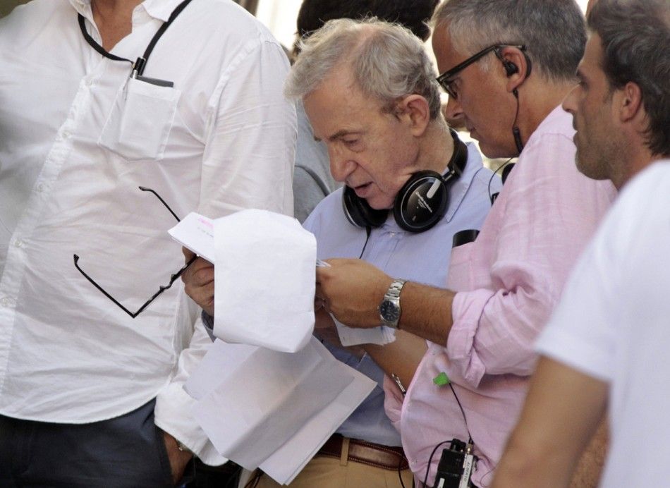 U.S. director Woody Allen reads during the filming of his next movie