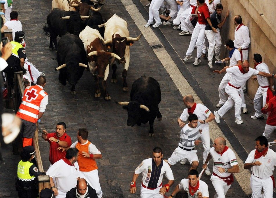 Victoriano del Rio fighting bulls run down Santo Domingo street during the sixth running of the bulls at the San Fermin festival in Pamplona.