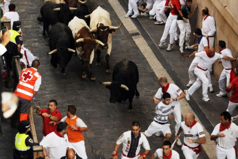 Victoriano del Rio fighting bulls run down Santo Domingo street during the sixth running of the bulls at the San Fermin festival in Pamplona.