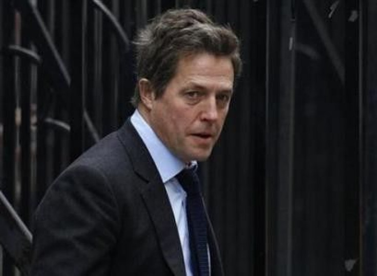 British actor Hugh Grant arrives at the Leveson Inquiry at the High Court in central London, November 21, 2011.