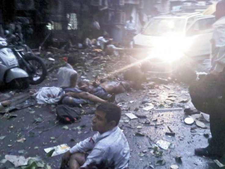 In this photo taken with a mobile phone, injured people lie on a street at the site of an explosion near the Opera House in Mumbai
