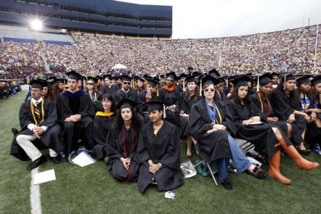 Graduating students listen to U.S. President Barack Obama speak at the University of Michigan commencement ceremony in Ann Arbor, Michigan May 1, 2010. The government is increasing its Pell Grant program and making loans directly.