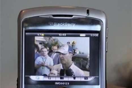 A journalist uses his Blackberry to take pictures of Mercedes Formula One driver Michael Schumacher 
