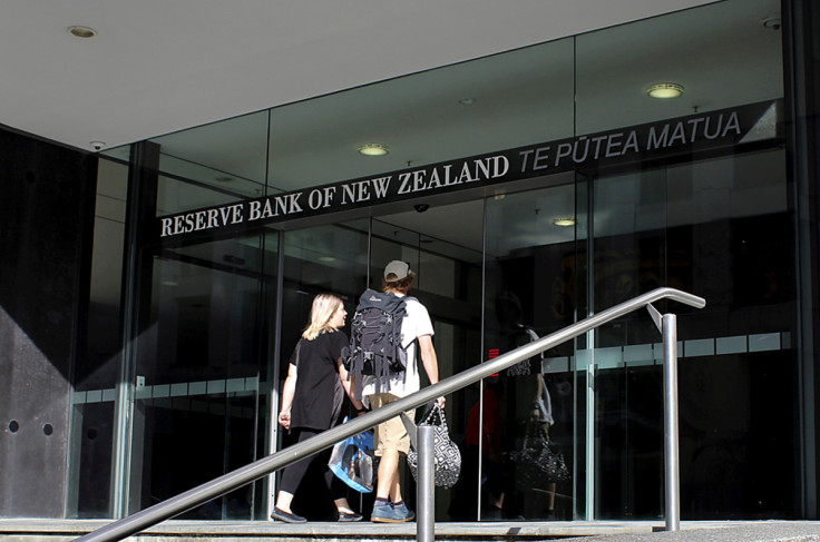 Two people walk towards the entrance of the Reserve Bank of New Zealand located in the New Zealand capital city of Wellington