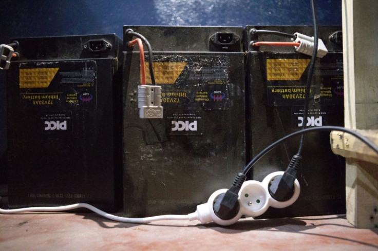 Rechargeable batteries used by electric motorcycle drivers are  charged in a store in Cotonou