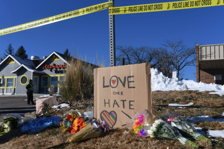 Bouquets of flowers and a sign reading "Love Over Hate" are left near Club Q, an LGBTQ nightclub in Colorado Springs, Colorado, on November 20, 2022