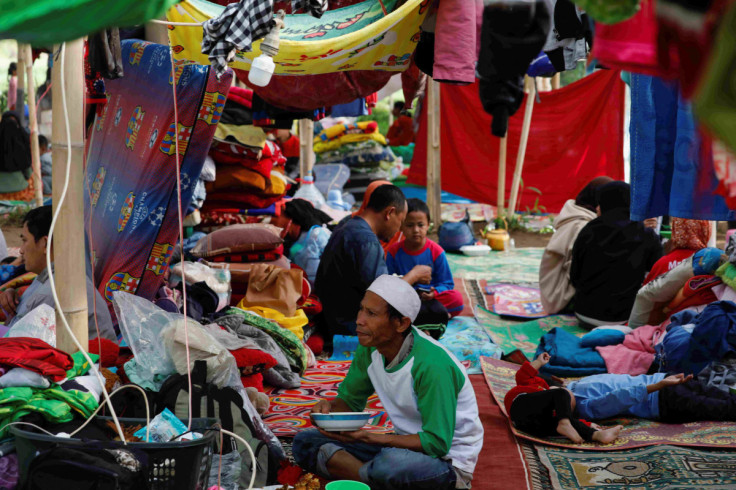 Locals are sheltered in a makeshift tent after Monday's earthquake hit Cianjur