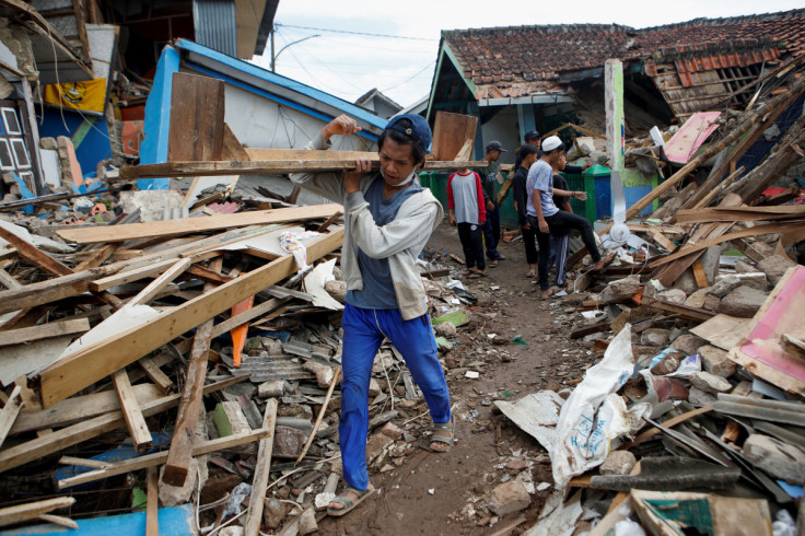 A local salvages goods from the rubble of a damaged house after Monday's earthquake hit Cianjur