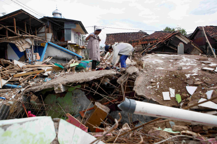 Locals salvage goods from the rubble of a damaged house after Monday's earthquake hit Cianjur