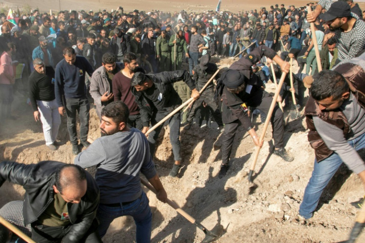 Syrian Kurds bury people killed in Turkish air strikes in al-Malikiyah in northeastern Hasakah province on November 21, 2022