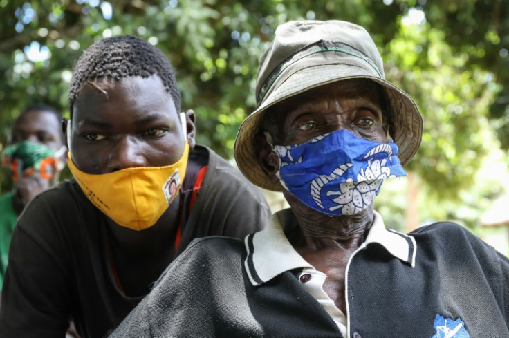 May 2021: residents of the Ugandan village of Lukodi, where dozens were killed in 2004, listen as the ICC sentences former LRA commander Dominic Ongwen