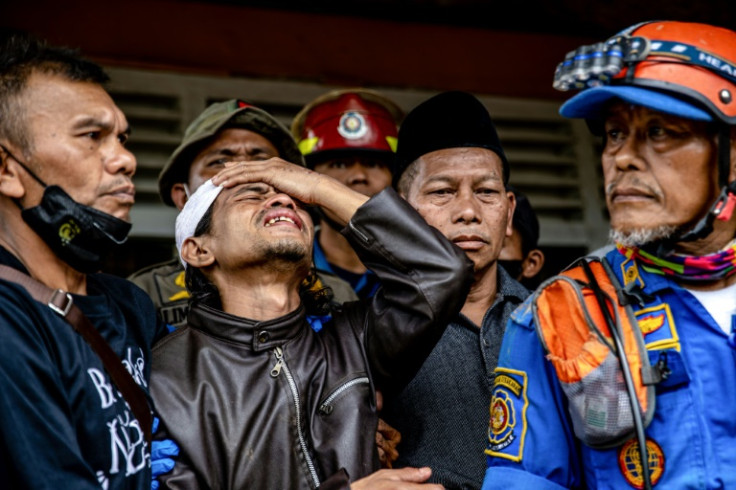 Cika's father Ahmad watched on holding his head in despair as her body was recovered