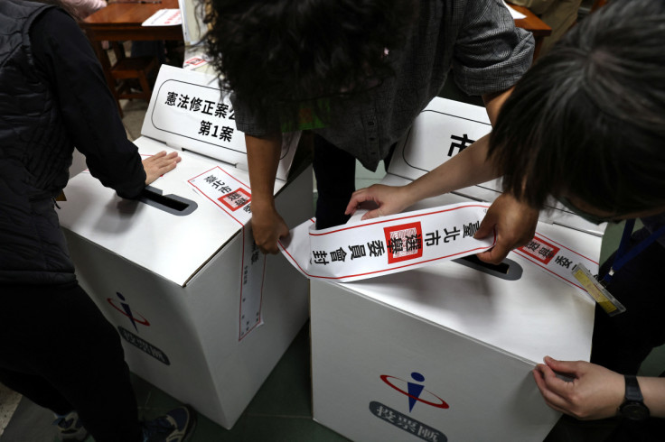 Staff prepare the ballot box ahead of election day in Taipei