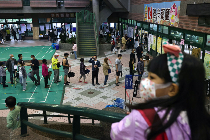 People line up to cast their vote on election day in Taipe