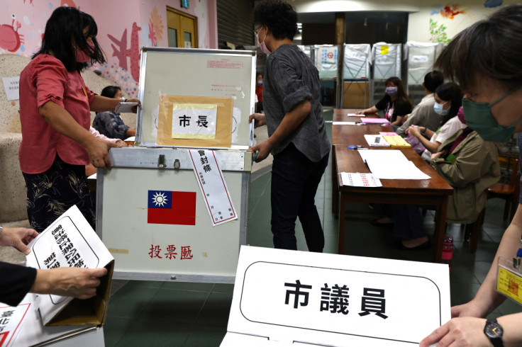 Staff prepare the ballot box ahead of election day in Taipei