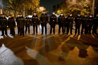 Police kept a watchful eye over a rally in Beijing held for the victims of a deadly fire and in protest against China's harsh anti-Covid policies