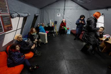 Local residents charge their devices, use internet connection and warm up inside an invincibility centre in Kyiv
