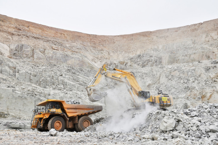 An excavator driven by Rosalie Guirou Kulga, 30, clears out rocks into a dumper at the gold mine, operated by Endeavour Mining Corporation in Hounde