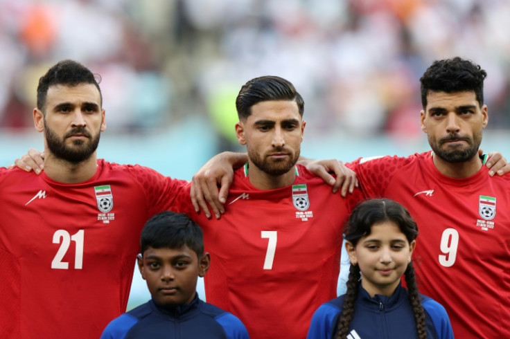 Iran's players, including captain Alireza Jahanbakhsh (C) chose not to sing the national anthem before their opening match