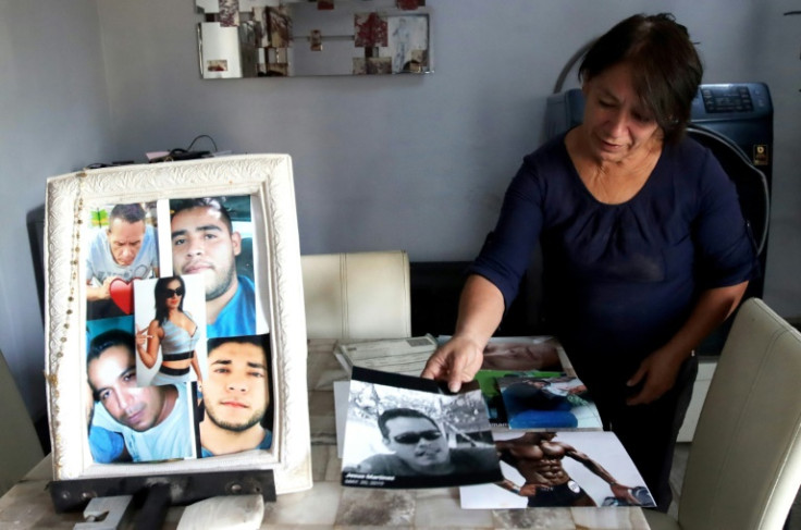 Guadalupe Camarena shows pictures of her five children, who are among more than 100,000 people missing in Mexico