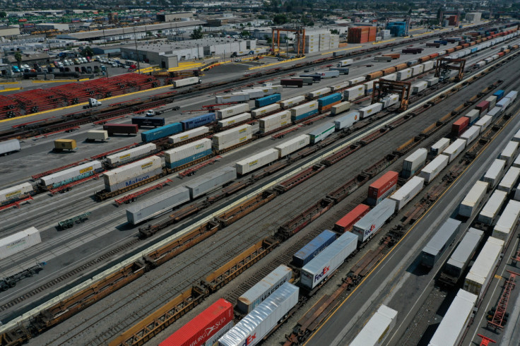 An aerial view of shipping containers and freight railway trains at the BNSF Los Angeles Intermodal Facility rail yard in Los Angele